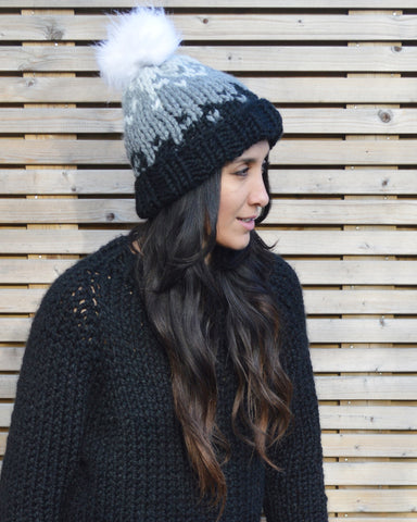 Front view of woman wearing handknit beanie in white, grey and black fade
