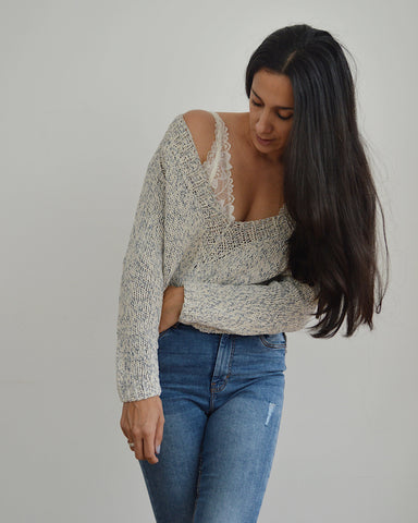 Woman wearing knitted v neck cotton sweater and jeans