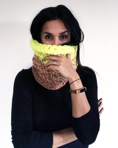Woman wearing snood in neon yellow fading to brown